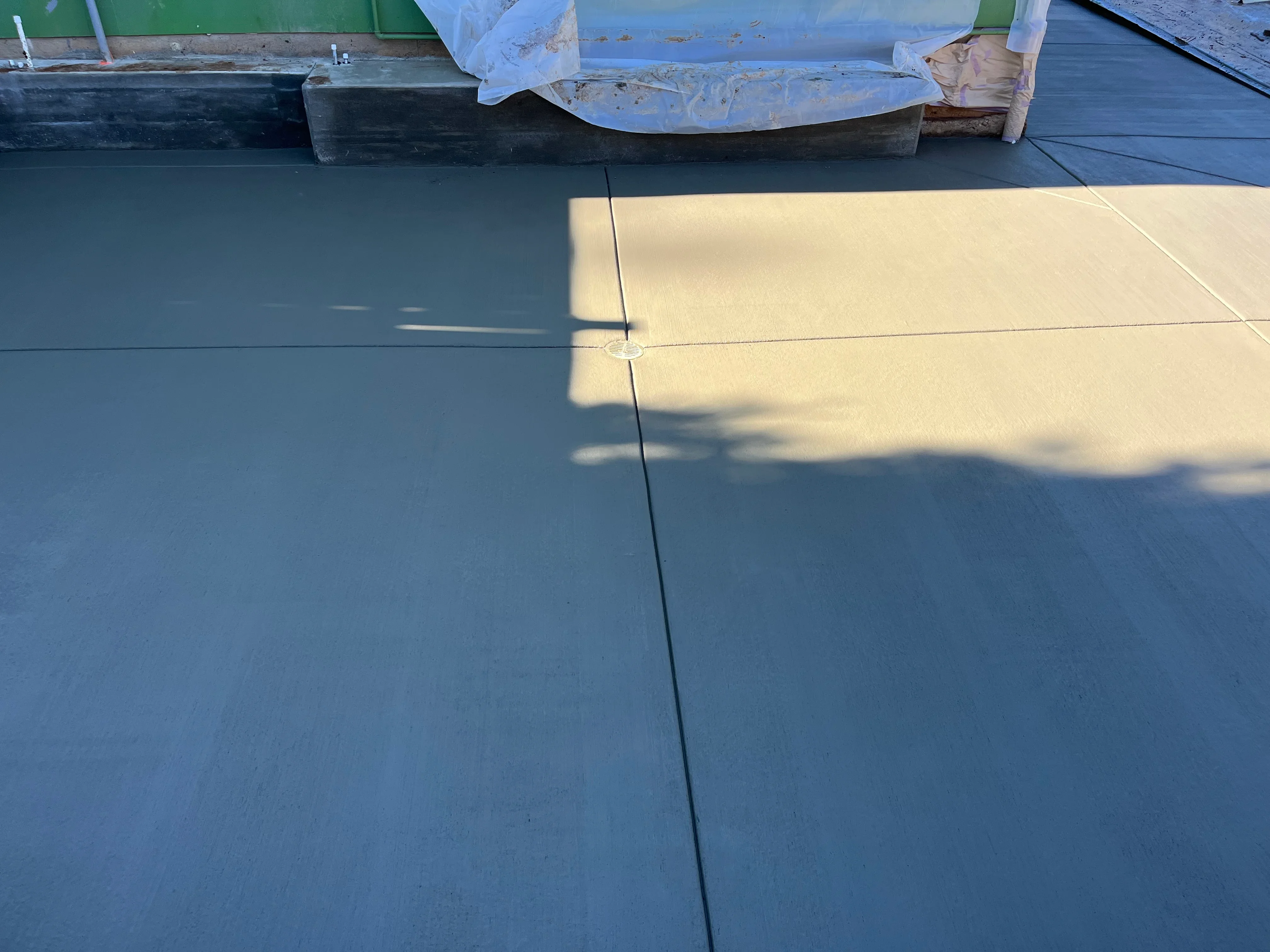 Flat roof installation with sealed seams and protective blue covering material