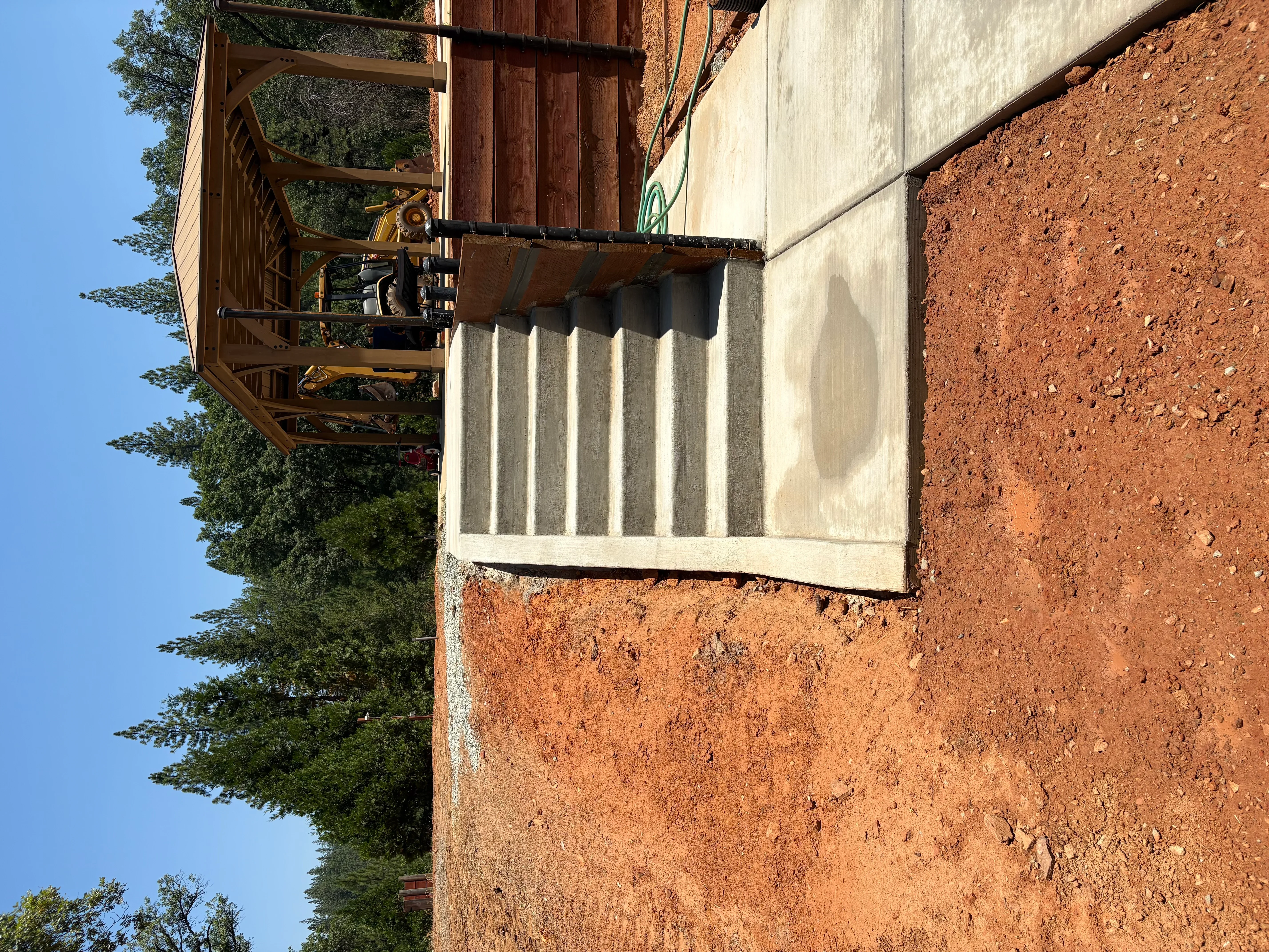Steel I-beam mounted on concrete foundation wall with metal support brackets and hardware