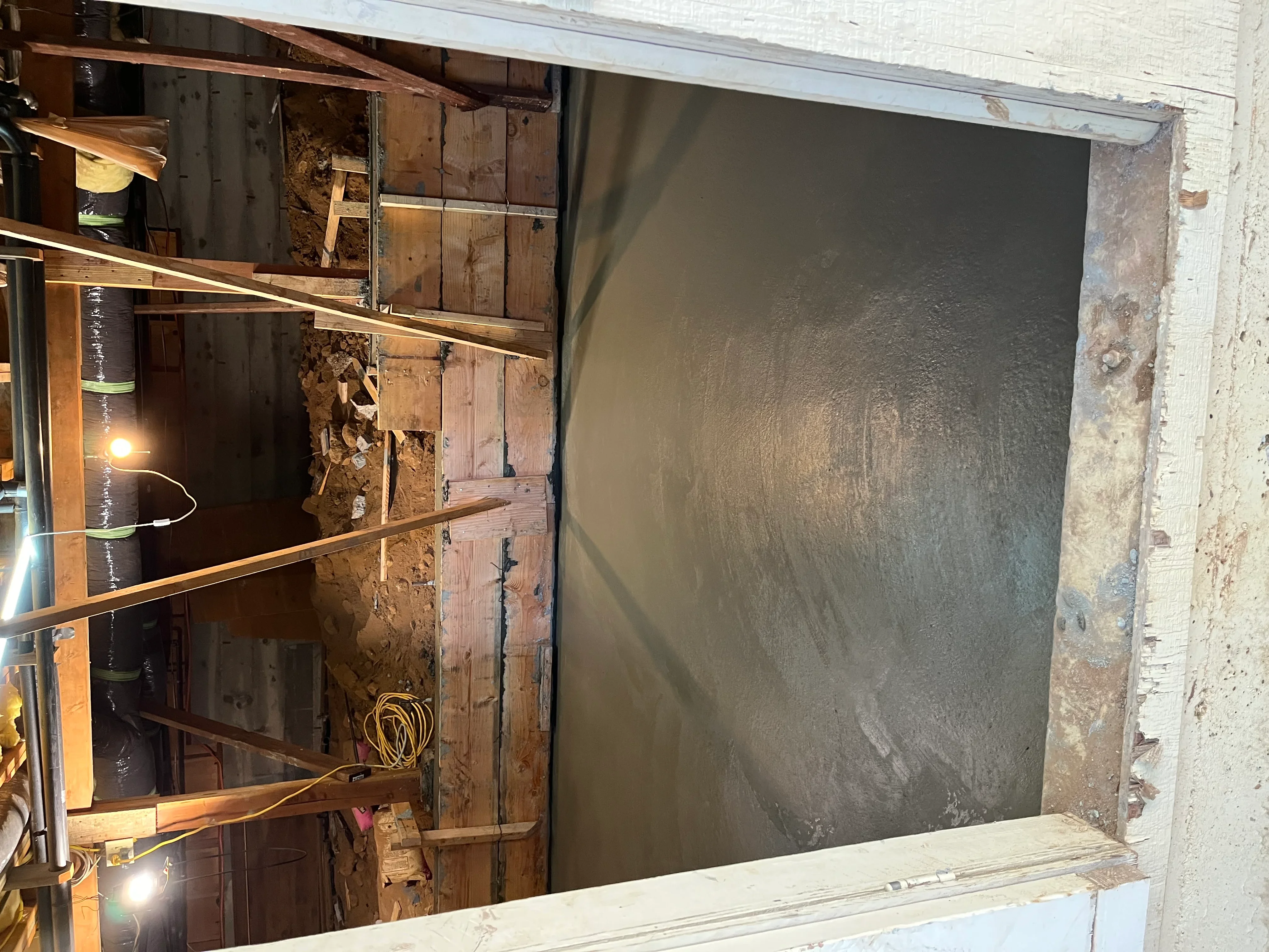 Interior wall framing with wood studs, metal bracing, and drywall ready for finishing