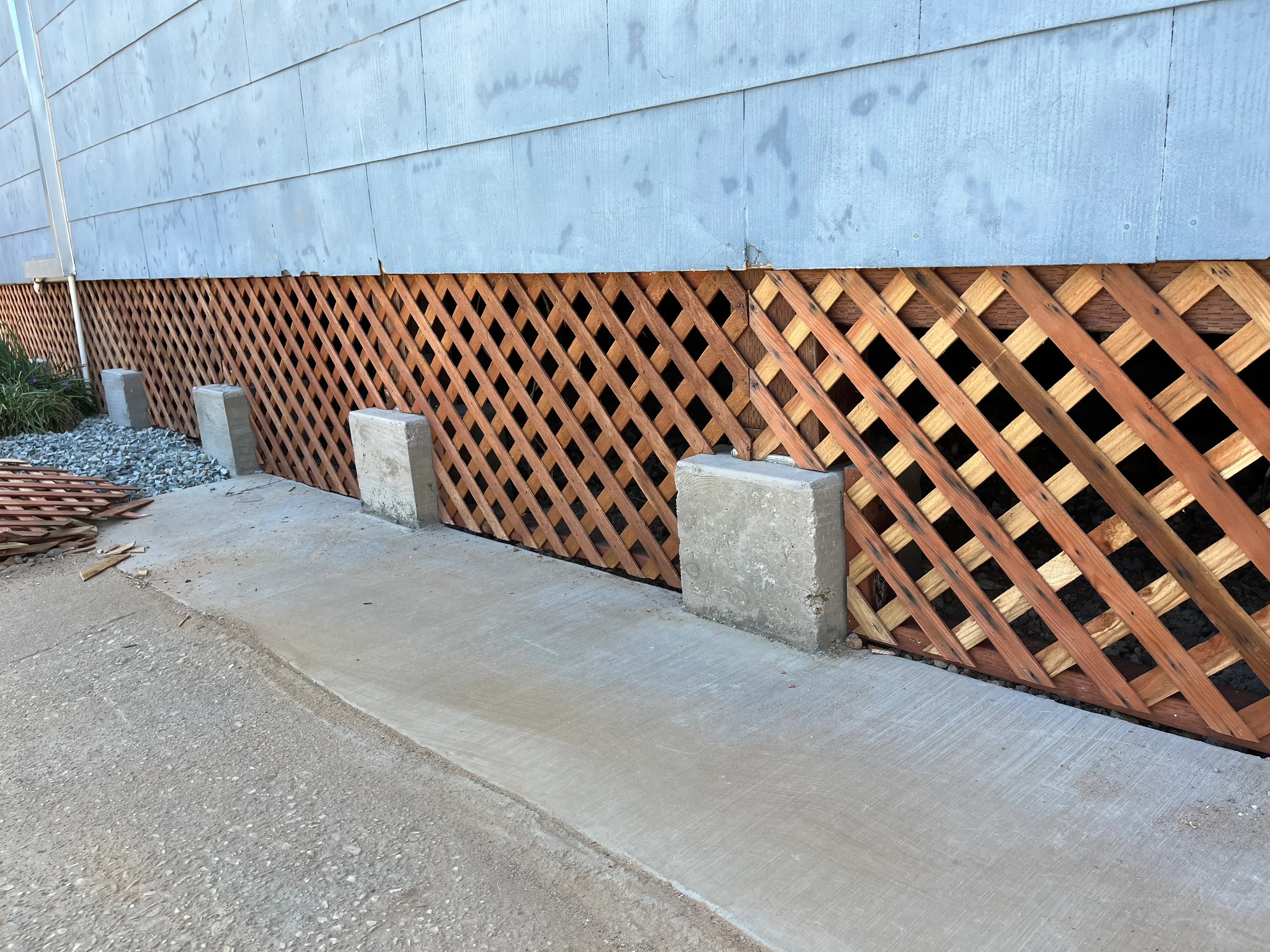 Cedar lattice foundation skirt with concrete apron and support piers