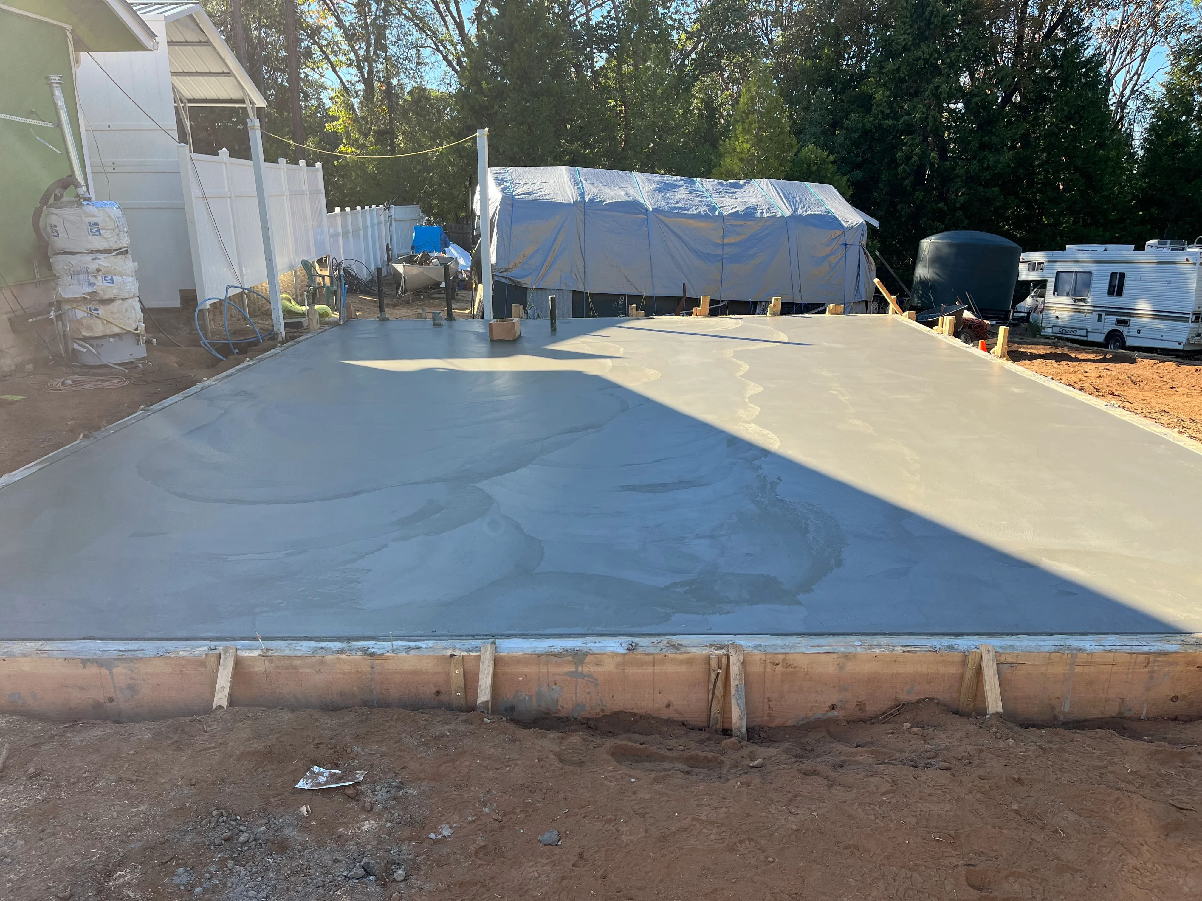 Finished concrete pad with troweled surface and wooden perimeter forms
