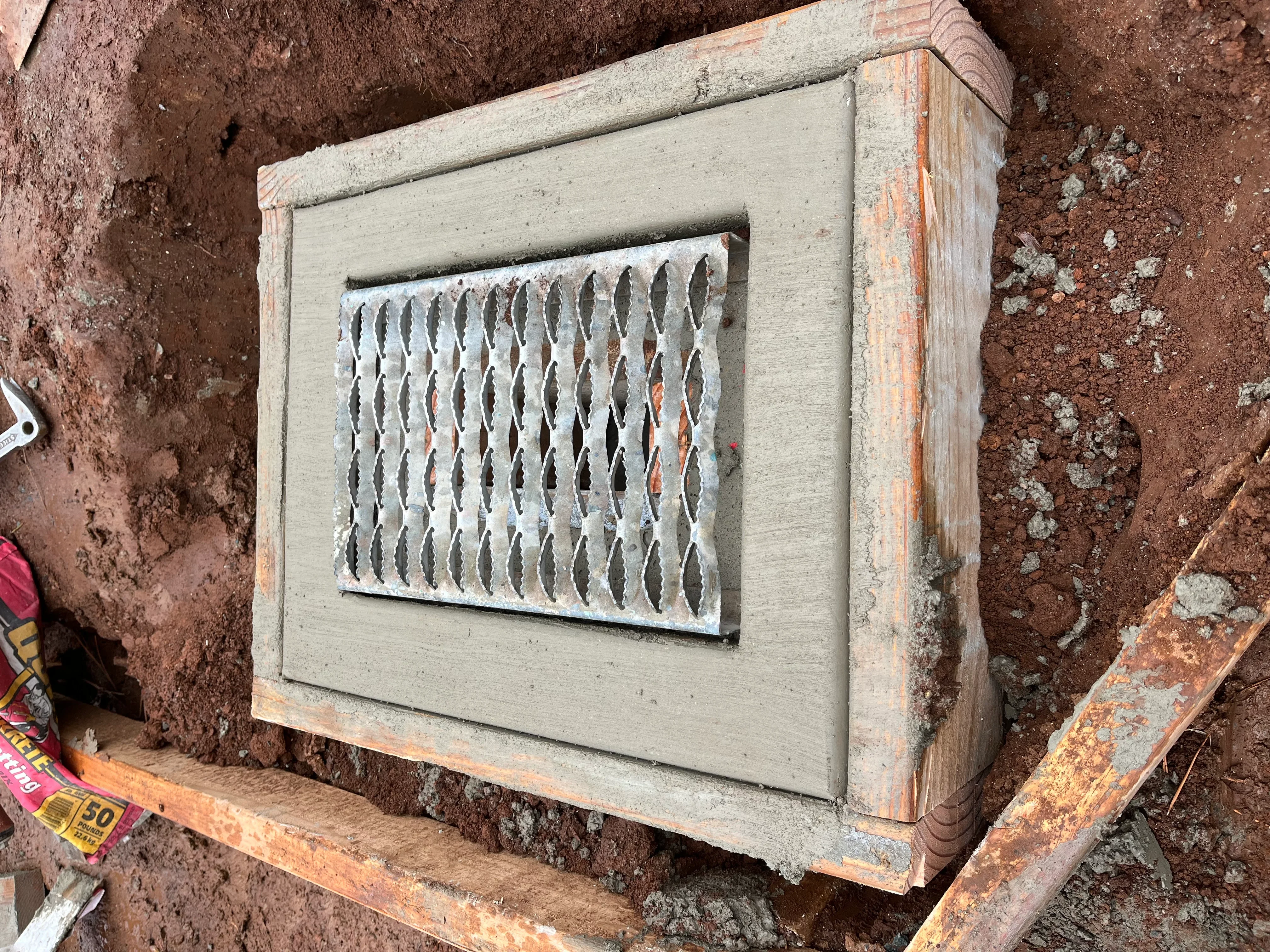 Wooden vent box with metal expanded grate insert, concrete and wood frame construction