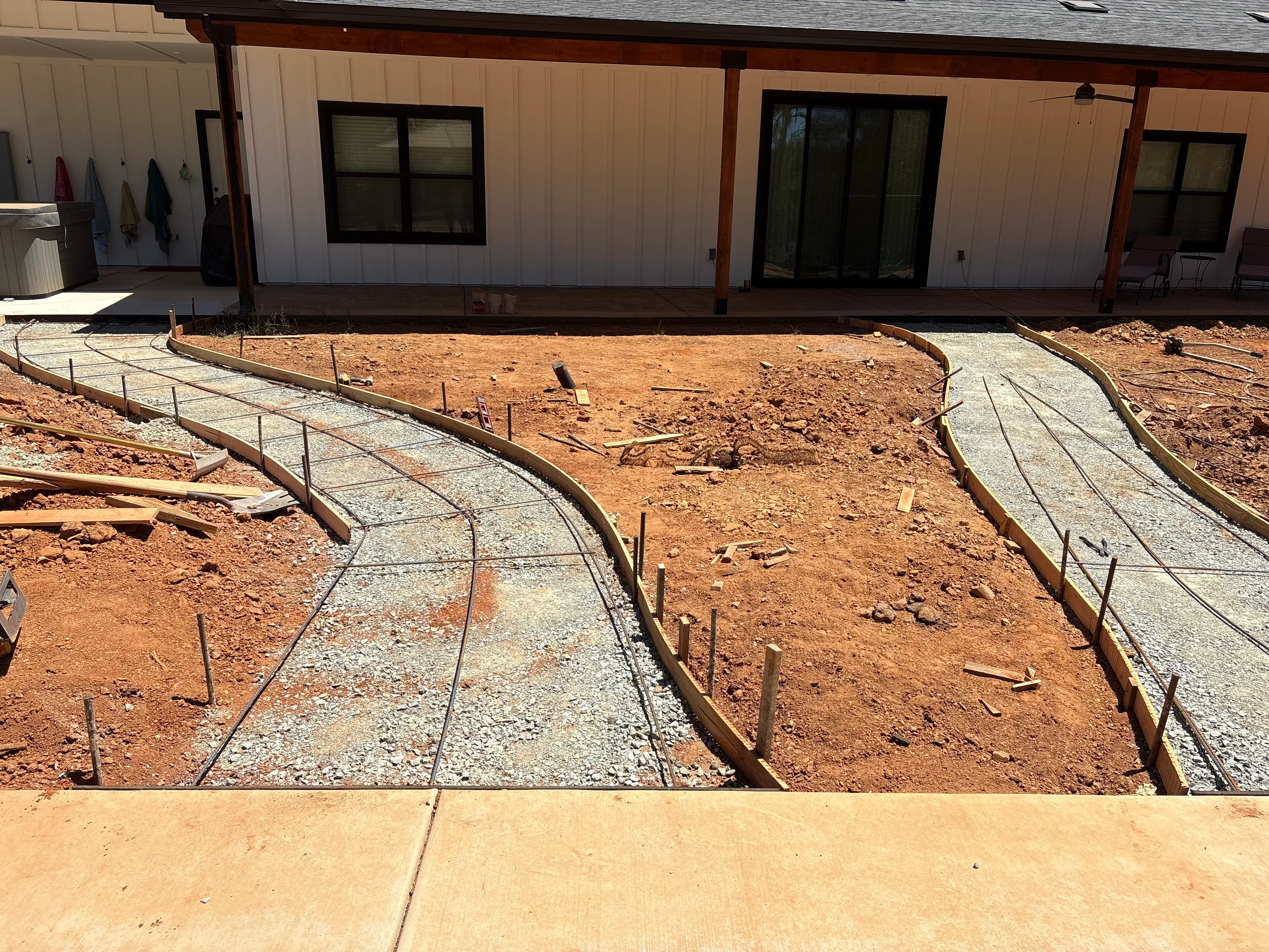 Concrete pathways with rebar reinforcement and timber edging during installation